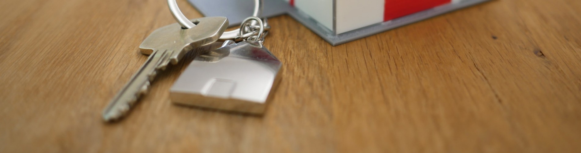 new home keys next to a miniature model house