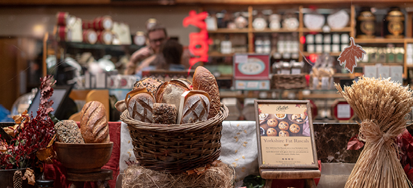 Shop counter with fresh bread and baguettes in a basket