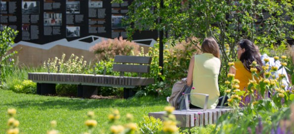 a couple sitting on a bench at elephant park in elephant and castle