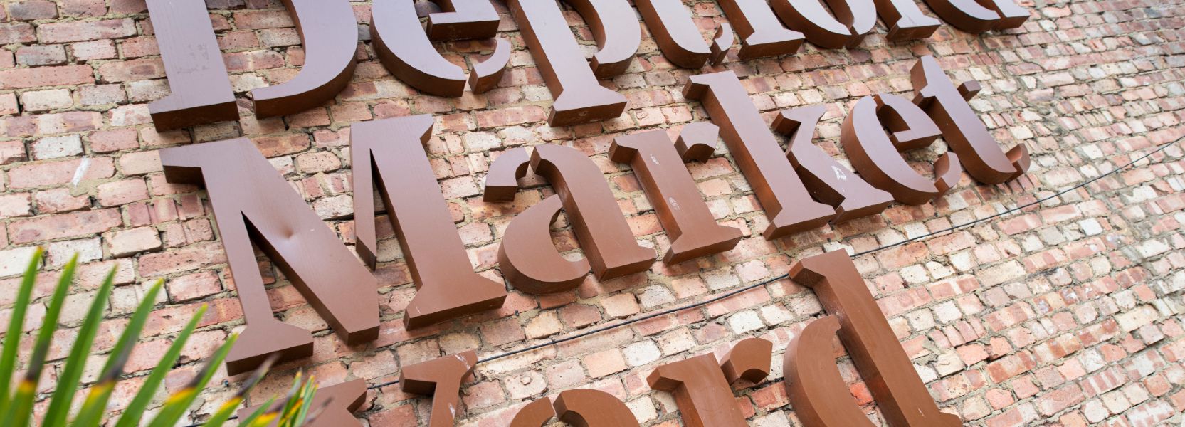 Deptford market yard sign on a brick wall