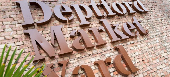 Deptford market yard sign on a brick wall