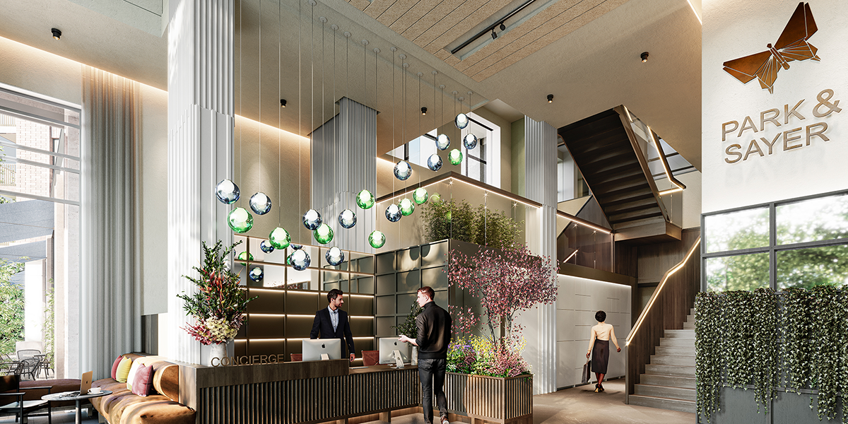 A spacious lobby with colourful plants and a bright open space. Decorated with feature lighting. A concierge desk features prominently.
