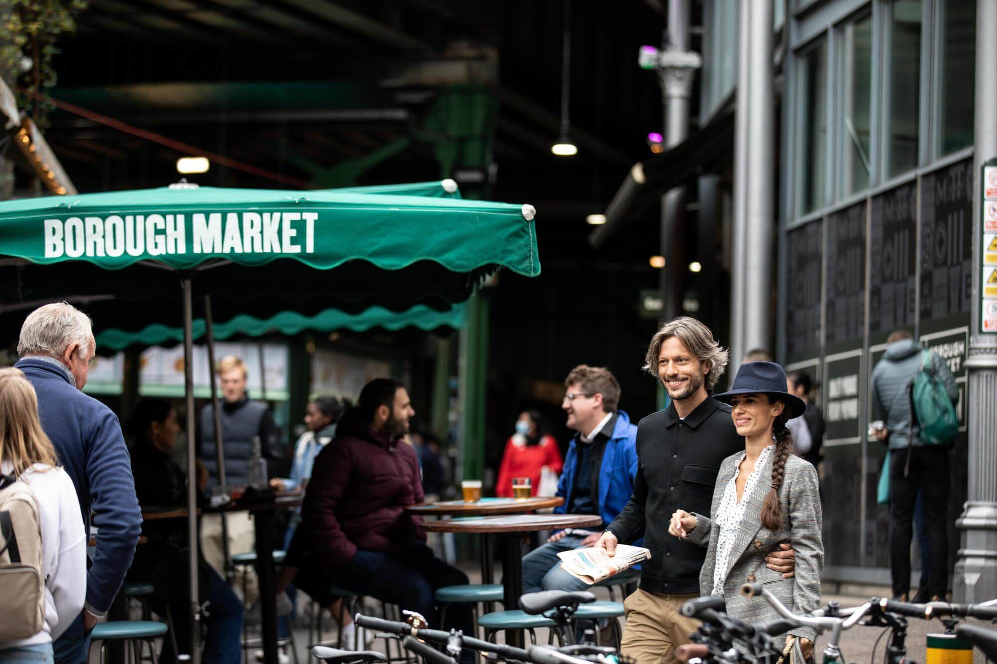 A couple walking through Borough Market near Elephant Park